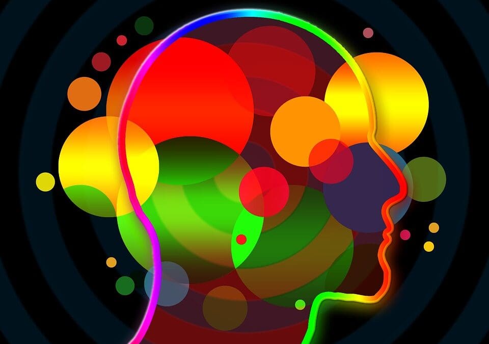 Colorful abstract profile of a human head with vibrant circles and light effects on a dark background." This alt text is succinct, descriptive, and captures the essential elements of the image, making it suitable for SEO purposes by including keywords related to the image's content.