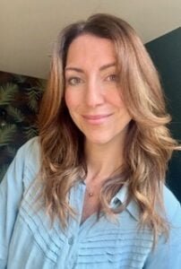 Female DBT Therapist wearing light blue shirt, with long hair.